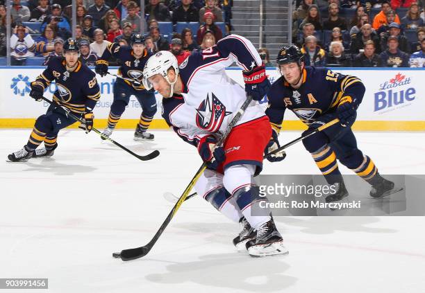 Jordan Schroeder of the Columbus Blue Jackets intercepts a pass in front of Jack Eichel of the Buffalo Sabres during an NHL game on January 11, 2018...