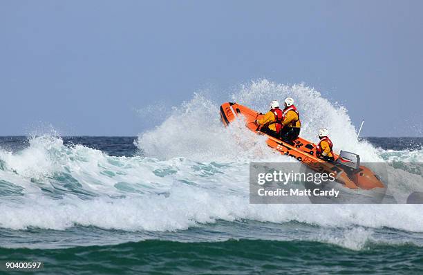 Lifeboat patrols as belly boarders take part in the World Belly Boarding Championships at Chapel Porth on September 6 2009 near St Agnes, England....