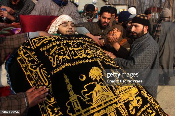 Mother prays near the body of a 16 year old Kashmiri rebel Farhan Ahmad Wani during funeral procession at Redwani village of kulgam District, 60KM...