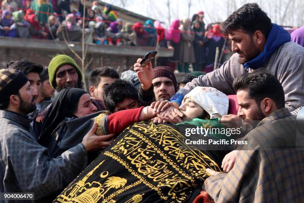 People offered funeral near the body of a 16 year old Kashmiri rebel Farhan Ahmad Wani at Redwani village of Kulgam District. Tawseef & a Civilian...