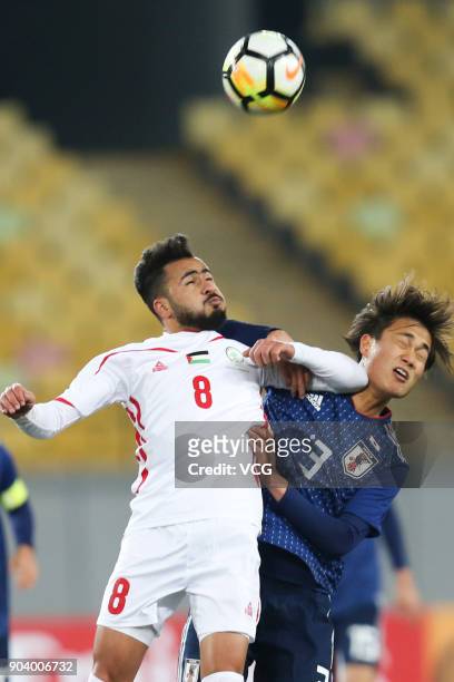 Itsuki Urata of Japan and Omar Sandouqa of Palestine compete for the ball during the AFC U-23 Championship Group B match between Japan and Palestine...