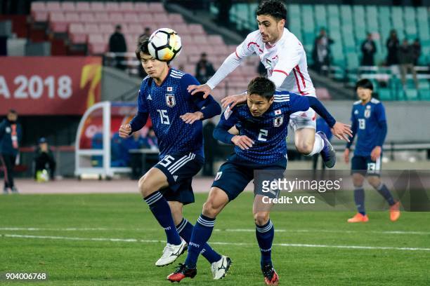 Honoya Shoji and So Fujitani of Japan and Yousef Al-Ashhab of Palestine compete for the ball during the AFC U-23 Championship Group B match between...