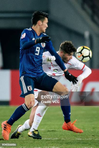 Kyosuke Tagawa of Japan and Michel Termanini of Palestine compete for the ball during the AFC U-23 Championship Group B match between Japan and...