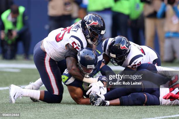 Benardrick McKinney and Andre Hal of the Houston Texans tackle Jimmy Graham during the game against the Seattle Seahawks at CenturyLink Field on...