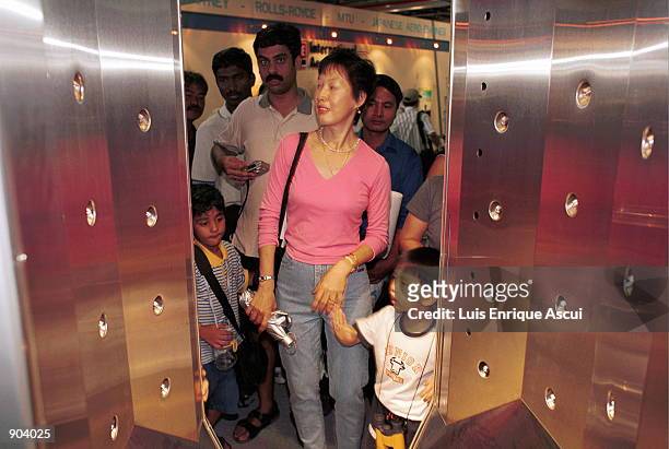 Mother and son walk through the "Ionscan," a product from Smiths Aerospace which is a non evasive method for screening people for any bomb making...