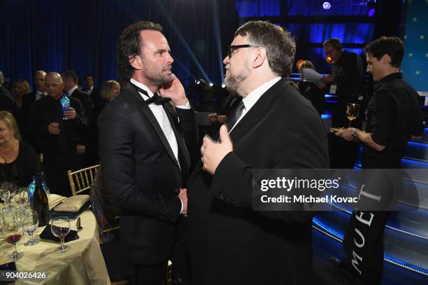 Actor Walton Goggins and director Guillermo del Toro attend Moet & Chandon celebrate The 23rd Annual Critics' Choice Awards at Barker Hangar on...