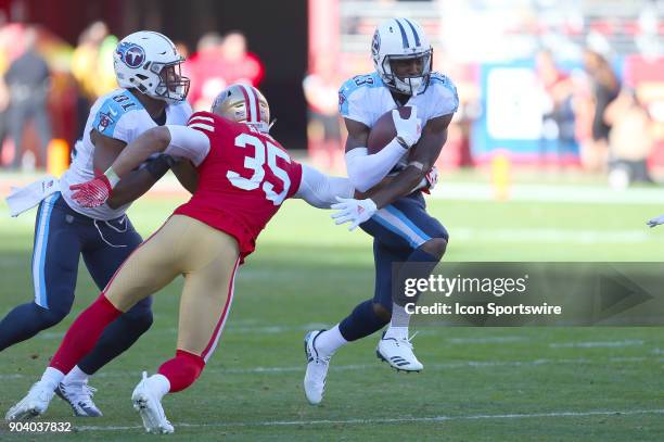 Tennessee Titans wide receiver Taiwan Taylor uses a block by Jonnu Smith to try and escape the grasp of Eric Reid during the San Francisco 49ers game...