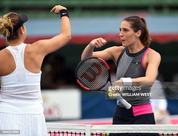 Andrea Petkovic of Germany and Belinda Bencic of Switzerland dance on the court during a rain break in the women's final of the Kooyong Classic...