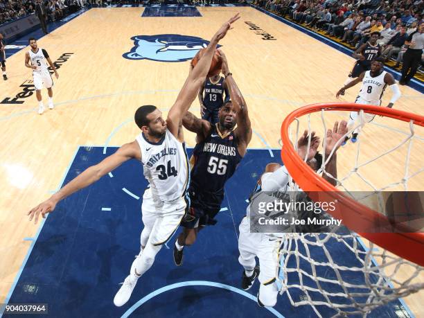 Brandan Wright of the Memphis Grizzlies attempts to block the shot by E'Twaun Moore of the New Orleans Pelicans during the game between the two teams...