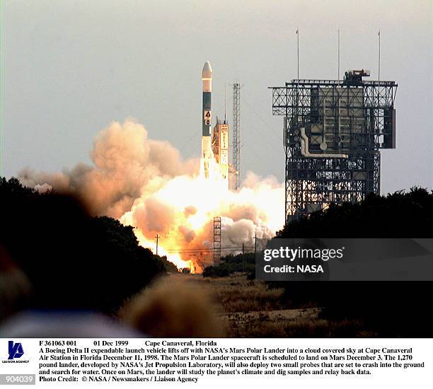 Boeing Delta II expendable launch vehicle lifts off with NASA's Mars Polar Lander into a cloud covered sky at Cape Canaveral Air Station in Florida...