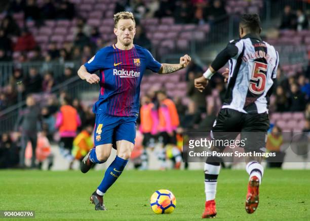 Ivan Rakitic of FC Barcelona competes for the ball with Cheik Doukoure of Levante UD during the La Liga 2017-18 match between FC Barcelona and...