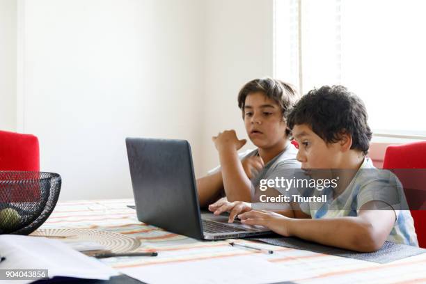 australian aboriginal boys using laptop computer at home - australian aboriginal children stock pictures, royalty-free photos & images