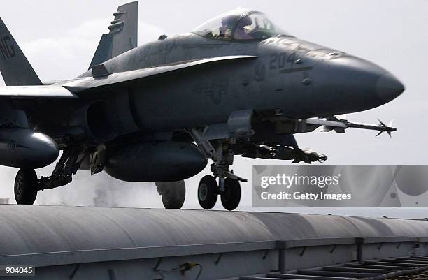 An F/A-18 "Hornet" loaded with laser guided bombs and air-to-air short range missiles taxis March 3, 2002 on the deck of the USS John C. Stennis. The...