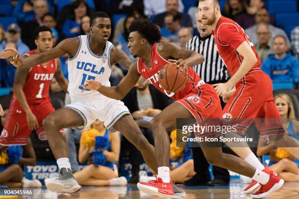 Utah Utes guard Kolbe Caldwell drives the ball inside with UCLA Bruins guard Kris Wilkes defending during the game between the Utah Utes and the UCLA...