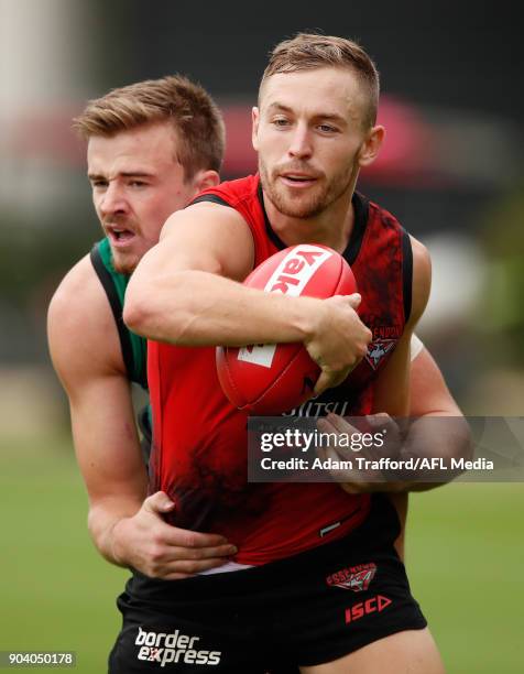 Devon Smith of the Giants is tackled by Martin Gleeson of the Bombers during the Essendon Bombers training session at The Hangar on January 12, 2018...