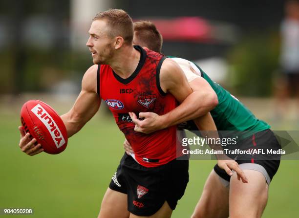Devon Smith of the Giants is tackled by Martin Gleeson of the Bombers during the Essendon Bombers training session at The Hangar on January 12, 2018...