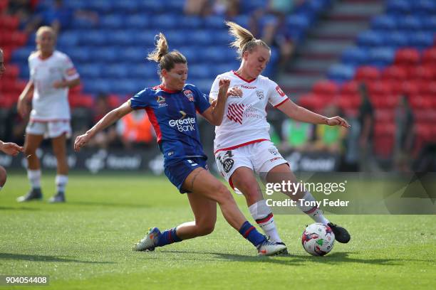 Grace Abbey of Adelaide contests the ball with Arin Gilliland of the Jets during the round 11 W-League match between the Newcastle Jets and Adelaide...