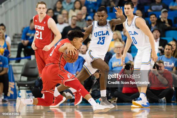 Utah Utes guard Sedrick Barefield drives the ball inside against UCLA Bruins guard Kris Wilkes during the game between the Utah Utes and the UCLA...