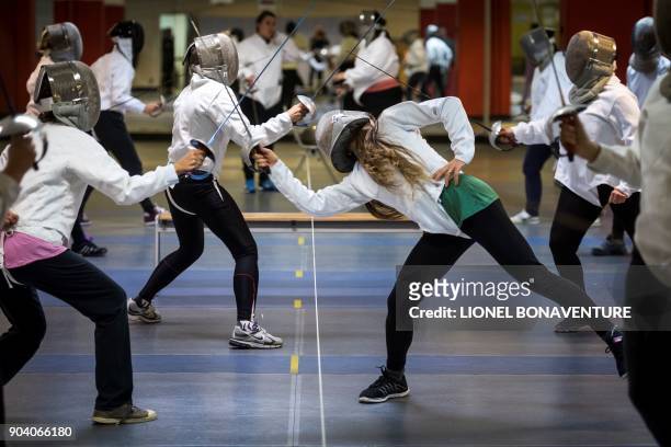 Women participate in a fencing training session organised by the association "Stop aux violences sexuelles" and the French Fencing Federation on...