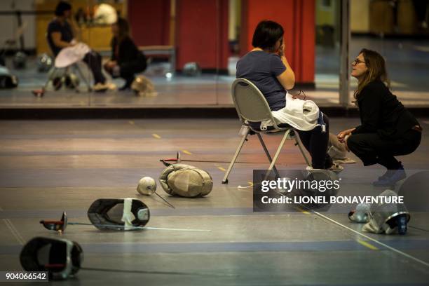 Woman speaks with a therapist as she participates in a fencing training session organised by the association "Stop aux violences sexuelles" and the...