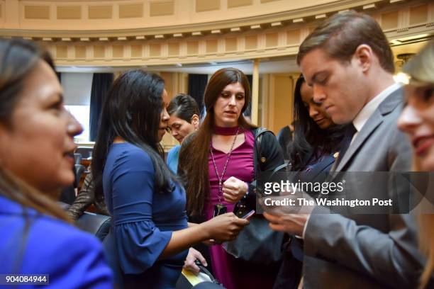 Delegate Danica Roem , C, chats with fellow lawmaker that include Charniele Herring, 2nd from L, Hala Ayala, 3rd from L, and Jennifer Carroll Foy,...
