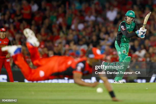 Dwayne Bravo of the Melbourne Renegades dives for a catch off Peter Handscomb of the Melbourne Stars during the Big Bash League match between the...