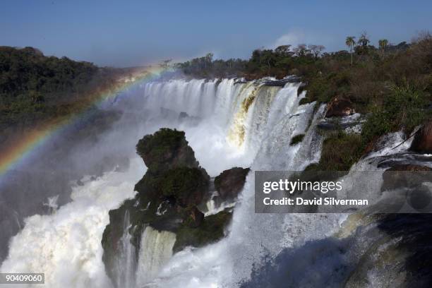 Rainbow arches over the San Martin and Mbigua cataracts of the Iguacu Falls in the Iguazu National Park on August 13, 2009 near the town of Puerto...