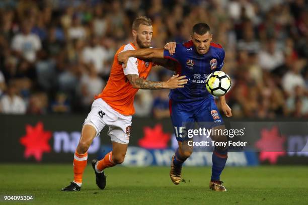 Andrew Nabbout of the Jets and Jacob Pepper of the Roar contest the ball during the round 16 A-League match between the Newcastle Jets and the...