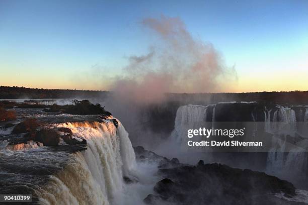 The setting sun casts its last light on the Iguacu Falls, as seen from the Iguacu National Park on August 12, 2009 near the town of Foz do Iguacu in...