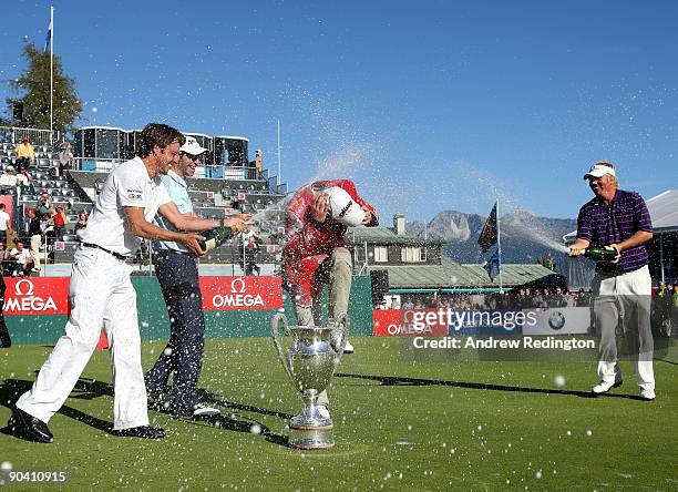 The winner Alexander Noren of Sweden is sprayed with champagne by Julien Clement of Switzerland, Bradley Dredge of Wales and Ross McGowan of England...