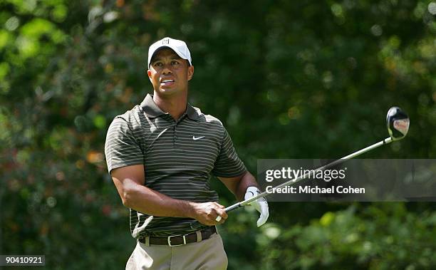 Tiger Woods of the United States reacts to his errant drive on the second hole during the third round of the Deutsche Bank Championship at TPC Boston...