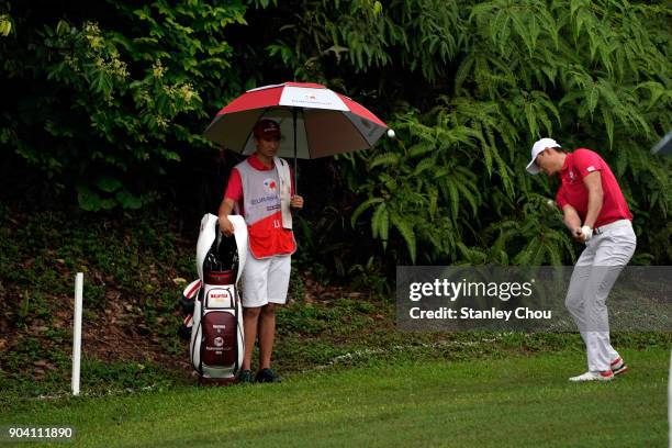 Haotong Li of team Asia in action during the fourballs matches on day one of the 2018 EurAsia Cup presented by DRB-HICOM at Glenmarie G&CC on January...