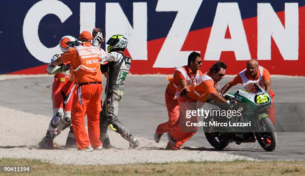 Andrea Iannone of Italy and Ongetta Ispa argues with Pol Espargaro of Spain and Derbi Racing after a crash during the last lap of the 125 cc race of...