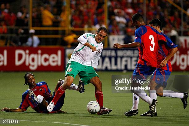 Mexico's Cuauhtemoc Blanco vies for the ball with Junior Diaz of Costa Rica during their FIFA 2010 World Cup qualifier at the Ricardo Saprissa...