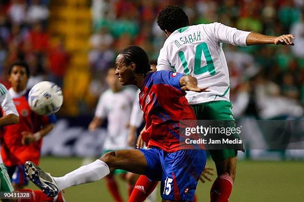 Mexico's Miguel Sabah vies for the ball with Junior Diaz of Costa Rica during their FIFA 2010 World Cup qualifier at the Ricardo Saprissa Stadium on...