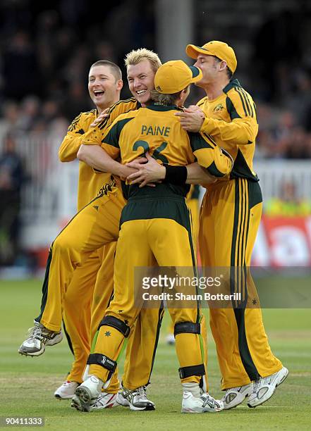 Brett Lee of Australia celebrates with team-mates Michael Clarke and Tim Paine after bowling Paul Colingwood of England to win the match during the...