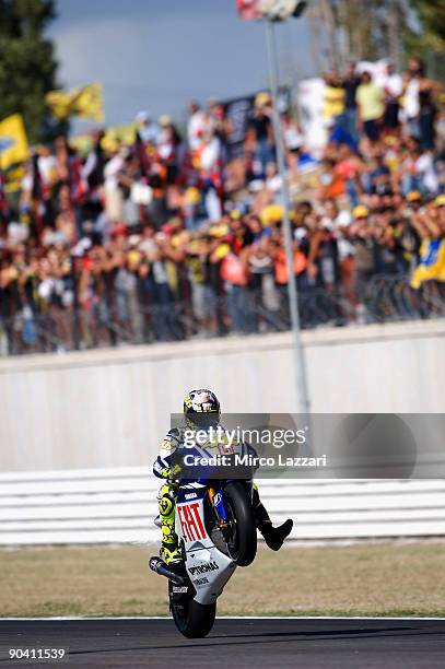 Valentino Rossi of Fiat Yamaha lifts his front wheel during warm-up for the MotoGP of San Marino on September 6, 2009 in San Marino, Italy.