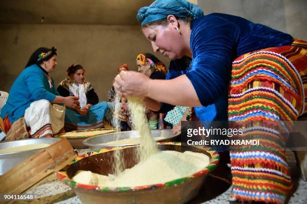 Algerian Berber women prepare couscous as they mark the Yennayer New Year in the village of Ait el-Kecem, south of Tizi-Ouzou, east of the capital...