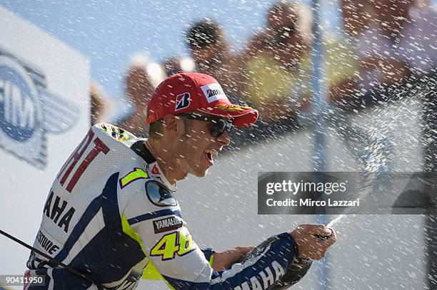 Valentino Rossi of Fiat Yamaha celebrates his victory on the podium after the MotoGP of San Marino on September 6, 2009 in San Marino, Italy.