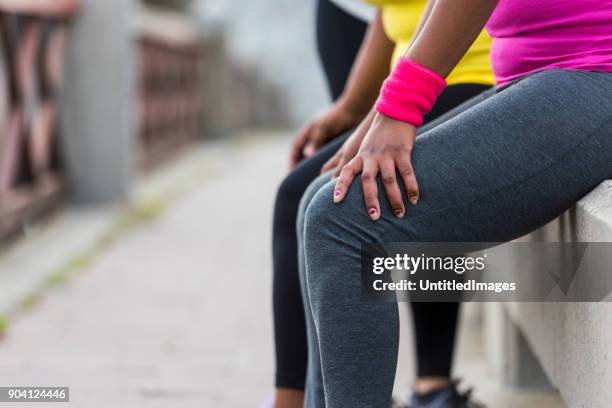 close up of women resting after exercise - fat legs stock pictures, royalty-free photos & images