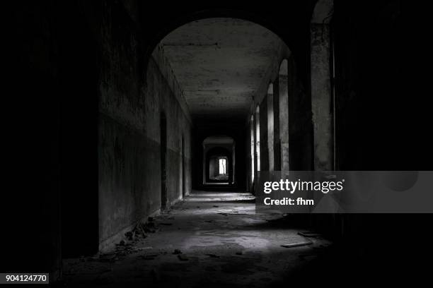 a long dark corridor in an abandoned hospital - psychiatric hospital stock pictures, royalty-free photos & images