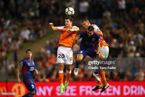 Shannon Brady of the Roar contests a header with Jason Hoffman of the Jets during the round 16 A-League match between the Newcastle Jets and the...