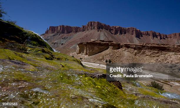 Waterfall created by natural "travertine" dams contrasts the high desert red rock cliffs at Band-E-Amir National Park September 6, 2009 in...