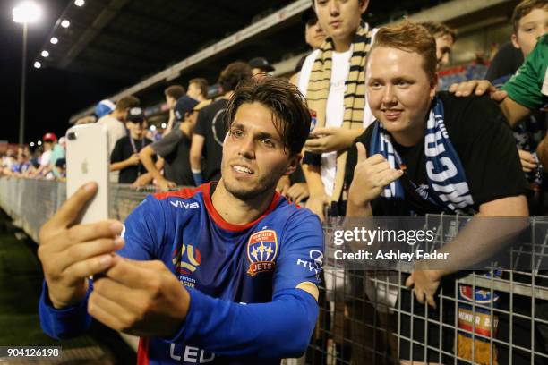 Patricio Rodriguez of the Jets takes a selfie with a fan after winning during the round 16 A-League match between the Newcastle Jets and the Brisbane...