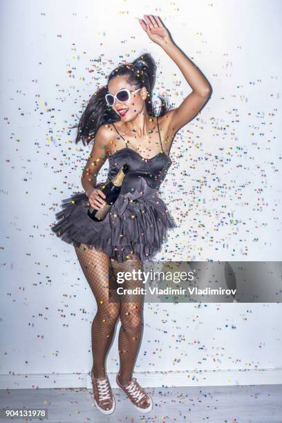 cheerful party girl holding champagne flute - black women in tights stock pictures, royalty-free photos & images