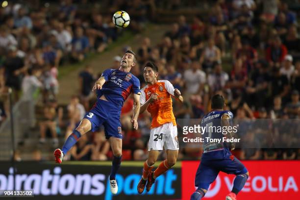 Jason Hoffman of the Jets and Connor O'Toole of the Roar contest a header during the round 16 A-League match between the Newcastle Jets and the...