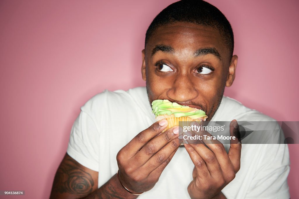 Man eating cupcake