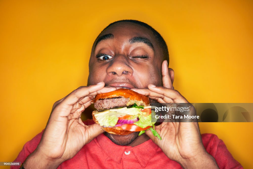 Man eating hamburger