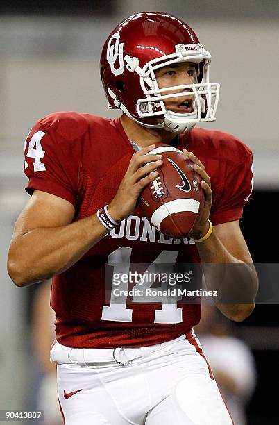 Quarterback Sam Bradford of the Oklahoma Sooners drops back to pass against the Brigham Young Cougars at Cowboys Stadium on September 5, 2009 in...