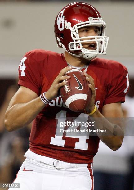 Quarterback Sam Bradford of the Oklahoma Sooners drops back to pass against the Brigham Young Cougars at Cowboys Stadium on September 5, 2009 in...